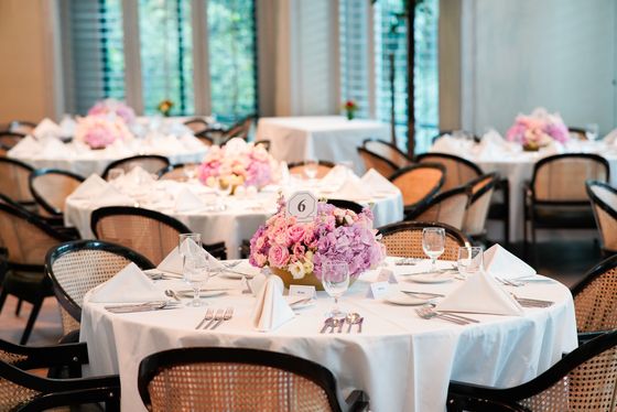 A reception table set with pink florals and fine china